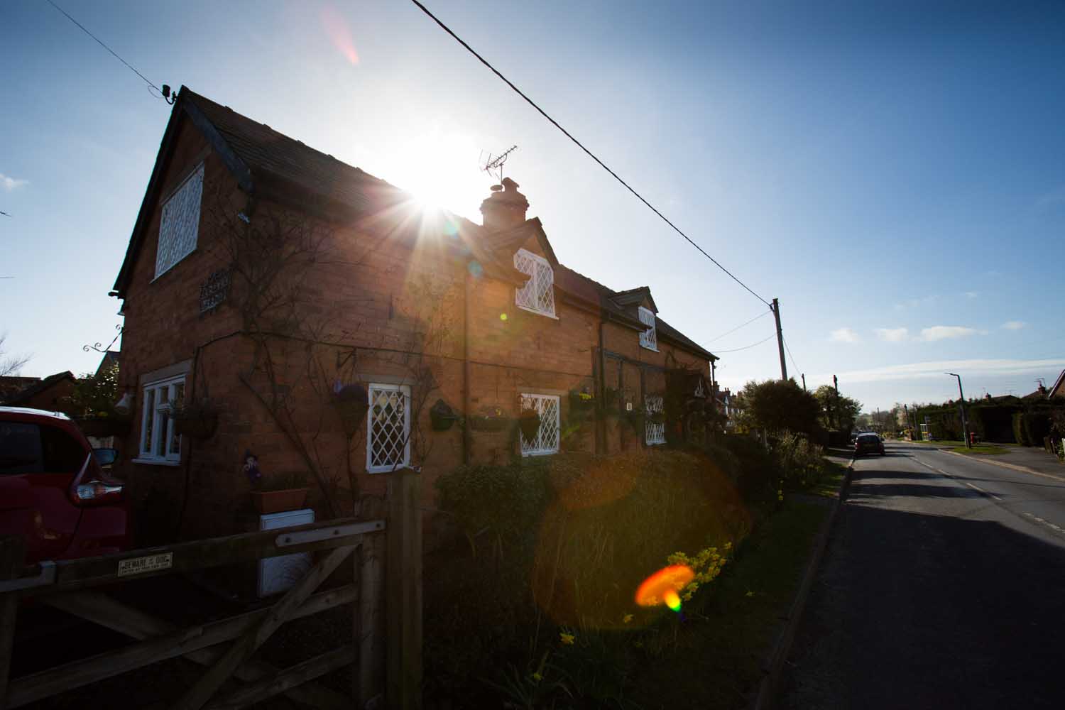 Picturesque silhouetted view of Cross O’ Th’ Hill Road, in the Cheshire village of No Man’s Heath.