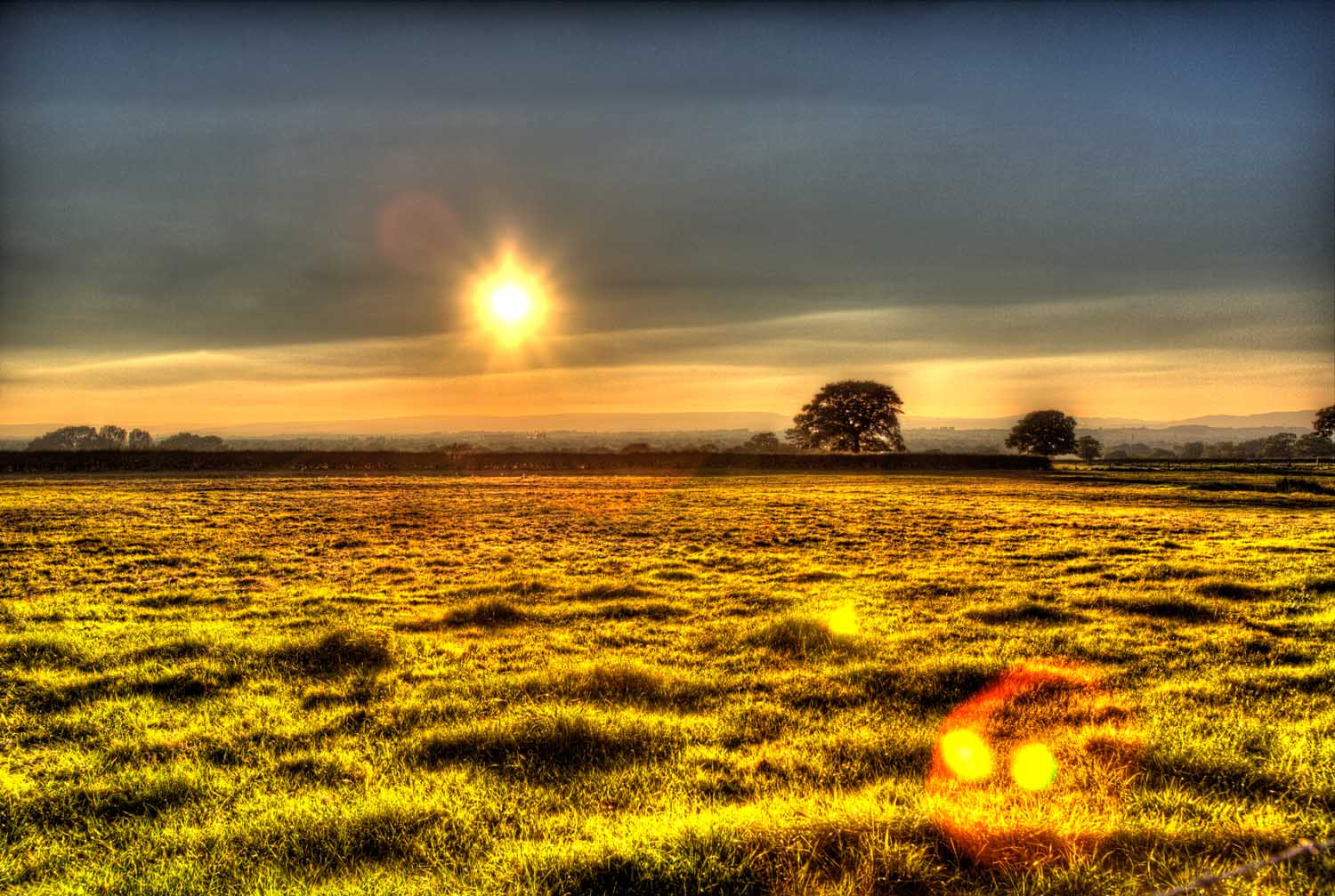 Village of Shocklach, Cheshire, England. Artistic sunset view over a Cheshire field near the village of Shocklach, toward the borders of Wales.