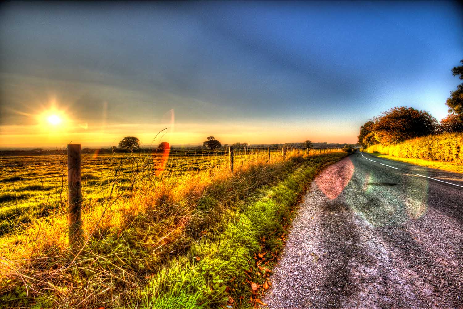 Village of Shocklach, Cheshire, England. Artistic sunset view over a rural road and Cheshire field, near the village of Shocklach.